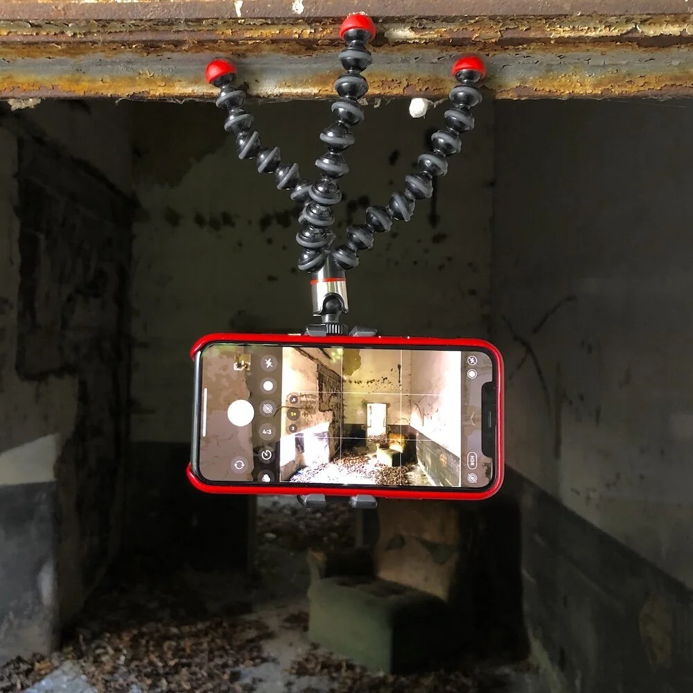 iPhone 11 with Gorillapod Magnetic attached to a window frame at an abandoned factory