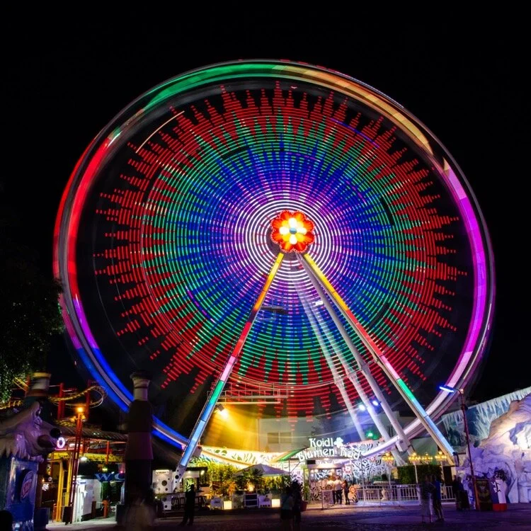 A long exposure of a Ferris wheel shot with a DSLR. We’ll apply the same technique to iPhone photography